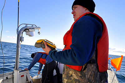 Project lead, Dr. Todd Hayden of Michigan State University, marks a receiver location on a GPS.